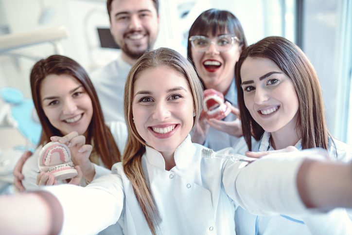 Happy Dentists Taking Selfie In Clinic